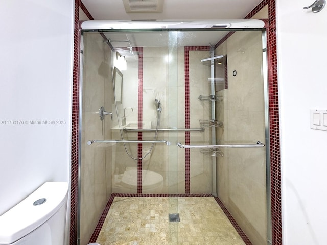 bathroom featuring visible vents, a stall shower, and toilet