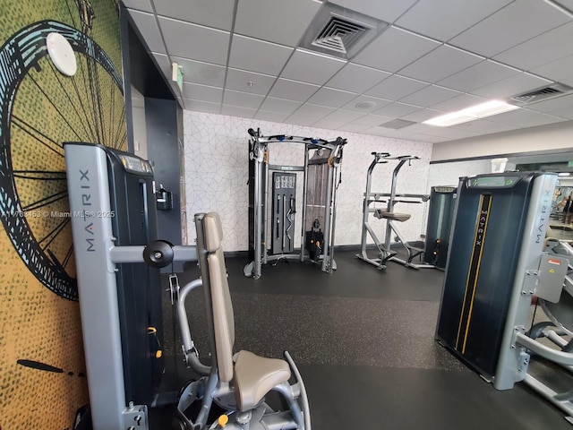 workout area with visible vents and a paneled ceiling