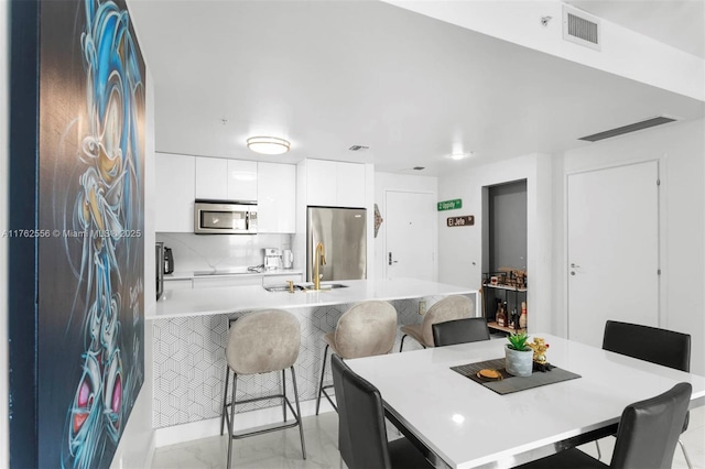 dining room featuring visible vents