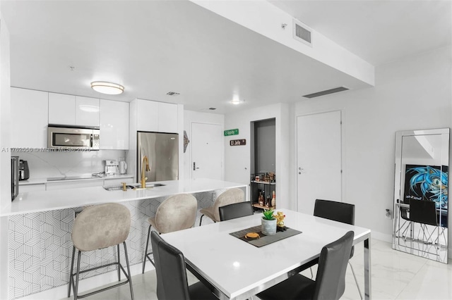 dining area with visible vents and marble finish floor