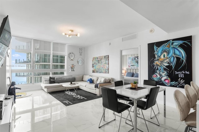 dining space featuring a chandelier, visible vents, and marble finish floor