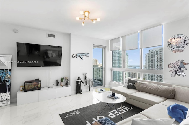 living area with visible vents, marble finish floor, and a chandelier