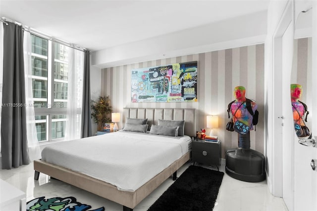 bedroom with floor to ceiling windows and marble finish floor