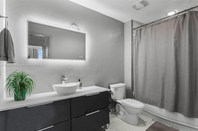 full bathroom featuring vanity, shower / bath combo with shower curtain, toilet, and marble finish floor