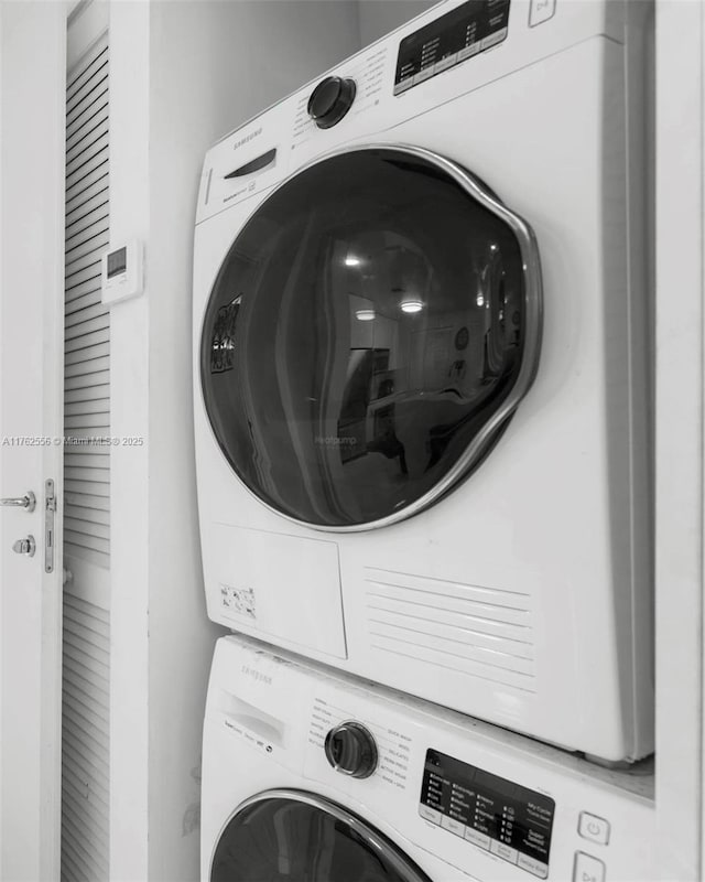 washroom with stacked washer / drying machine and laundry area