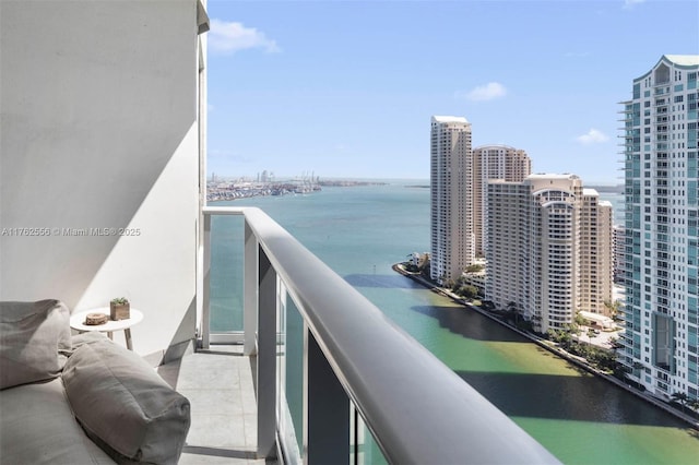 balcony with a view of city and a water view