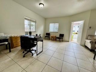 office area with a wealth of natural light and light tile patterned flooring