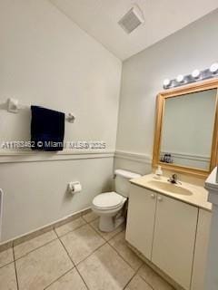 bathroom featuring vanity, tile patterned floors, toilet, and visible vents