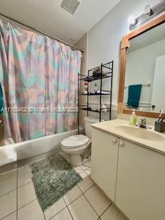 full bath with tile patterned floors, visible vents, toilet, shower / bath combination with curtain, and vanity