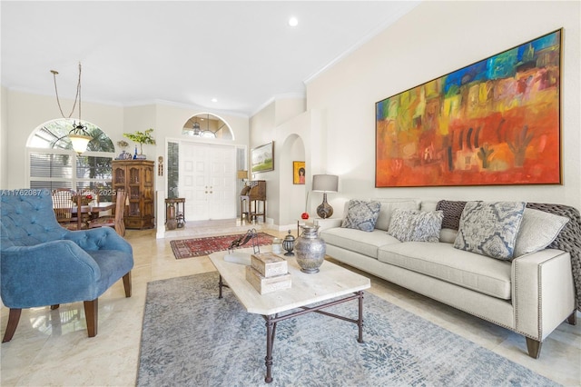 living room featuring light tile patterned floors, recessed lighting, arched walkways, and ornamental molding