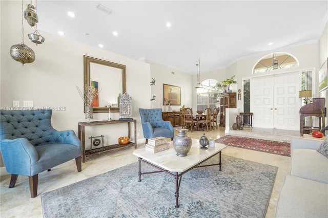 living area featuring recessed lighting, light tile patterned flooring, and crown molding