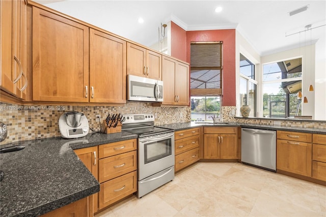 kitchen featuring tasteful backsplash, stainless steel appliances, crown molding, and dark stone counters