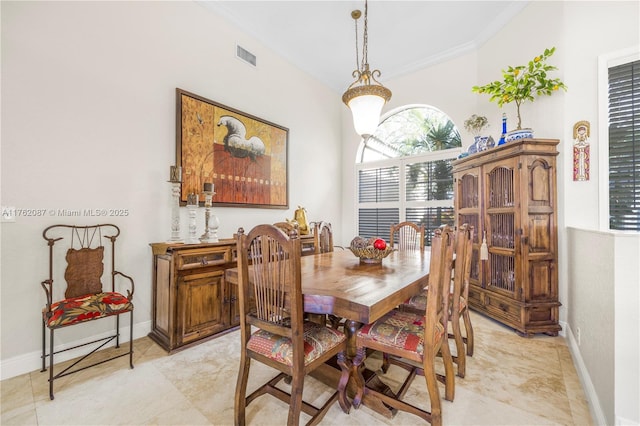 dining area featuring crown molding, baseboards, and visible vents