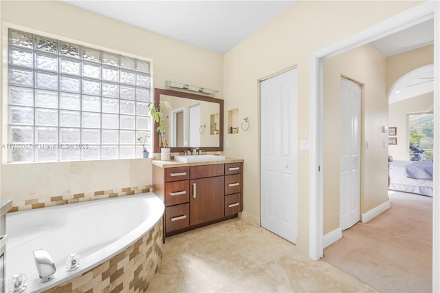 full bathroom with a garden tub and vanity