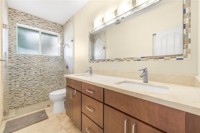 full bathroom with a shower stall, toilet, and a sink