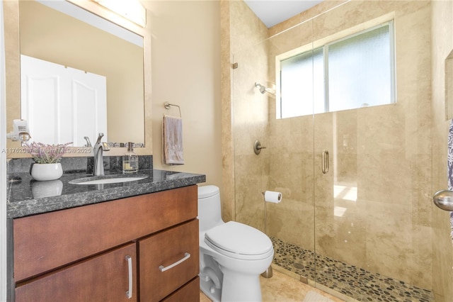 bathroom with vanity, toilet, and a stall shower