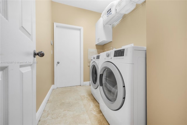 washroom with light tile patterned flooring, cabinet space, independent washer and dryer, and baseboards