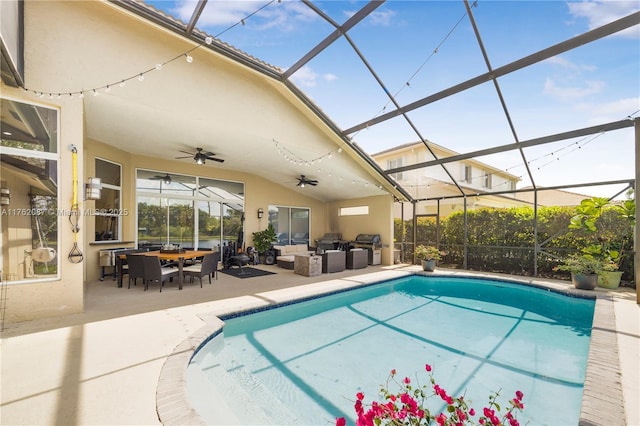 pool with a ceiling fan, a lanai, outdoor lounge area, and a patio area