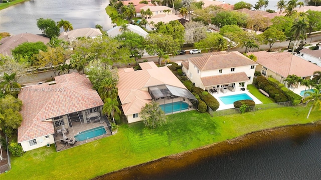 drone / aerial view featuring a residential view and a water view