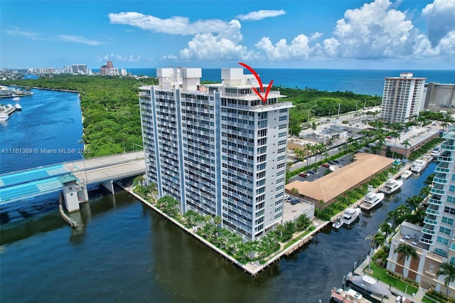 drone / aerial view featuring a view of city and a water view