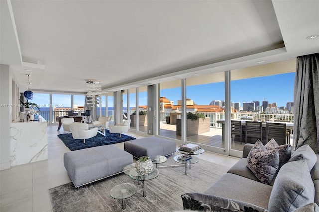 living area with tile patterned flooring, a wall of windows, a view of city, and a raised ceiling