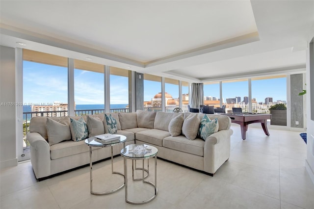 living room with a view of city and a raised ceiling