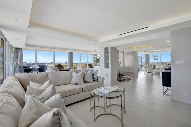 living area featuring a city view, recessed lighting, and a tray ceiling