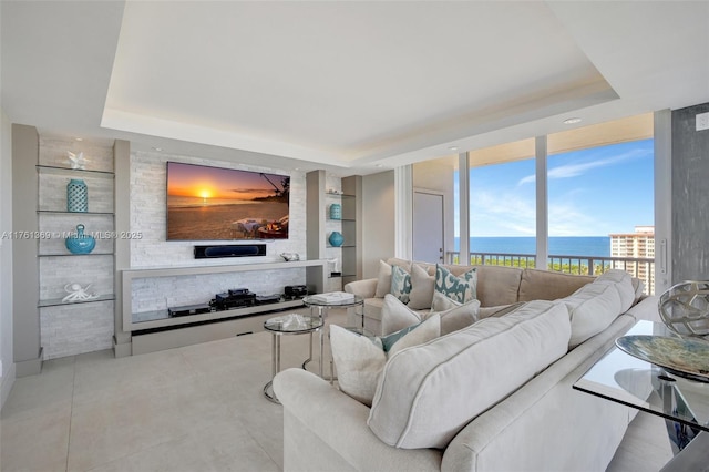 living area featuring expansive windows and a raised ceiling