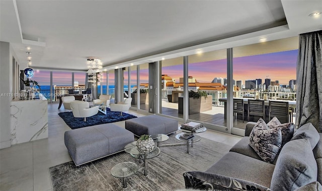 tiled living room with expansive windows and a raised ceiling
