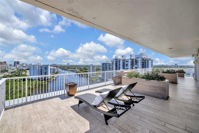 view of patio with a balcony and a city view