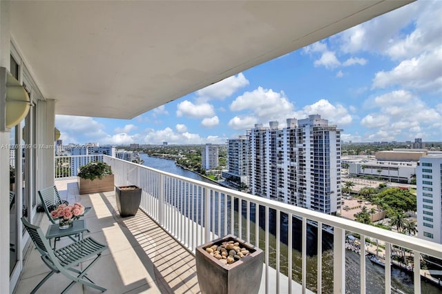balcony featuring a water view and a view of city