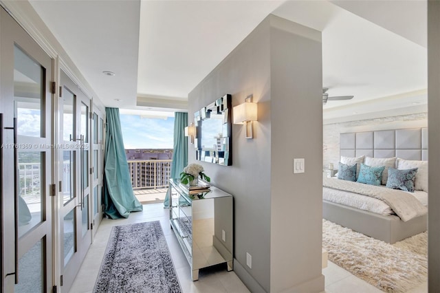corridor featuring baseboards and light tile patterned flooring