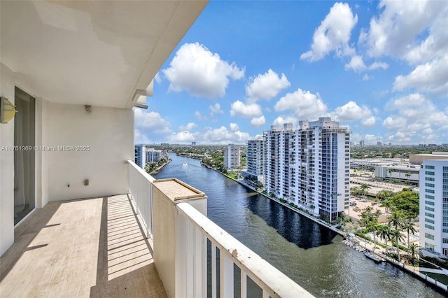 balcony with a water view and a city view