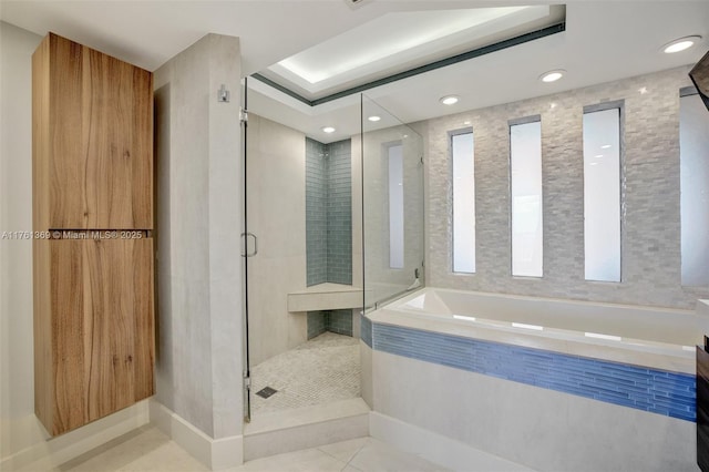 full bath with tile patterned flooring, a garden tub, and a stall shower