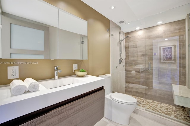 bathroom with visible vents, a shower stall, toilet, recessed lighting, and vanity