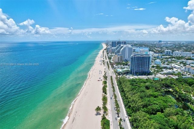 birds eye view of property featuring a view of city, a water view, and a view of the beach