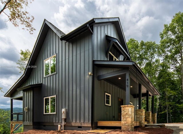 view of side of property featuring crawl space and board and batten siding