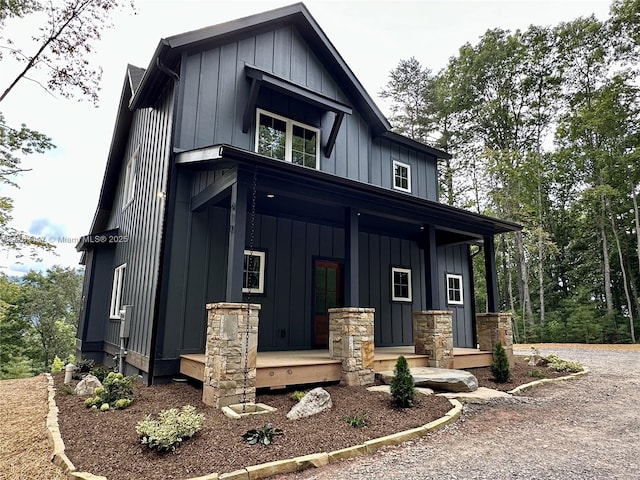 modern farmhouse style home featuring board and batten siding, covered porch, and driveway