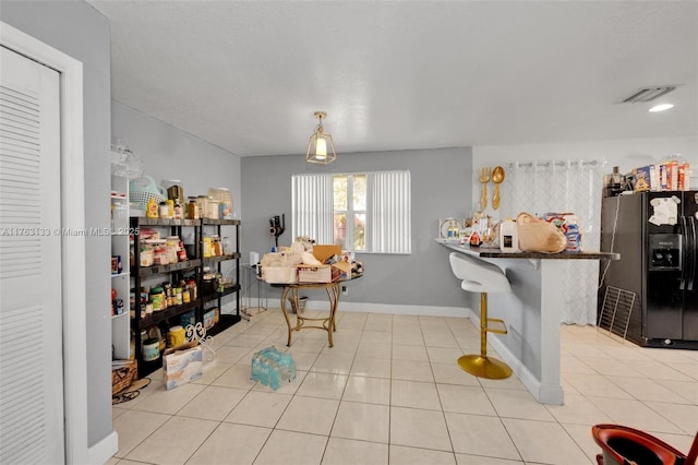 dining area featuring tile patterned floors, baseboards, and visible vents