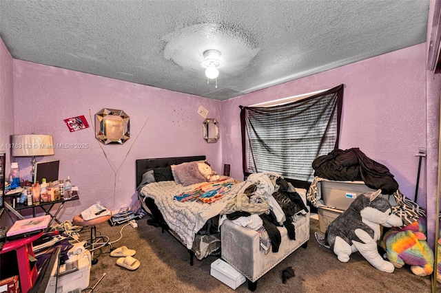 carpeted bedroom with a textured wall and a textured ceiling