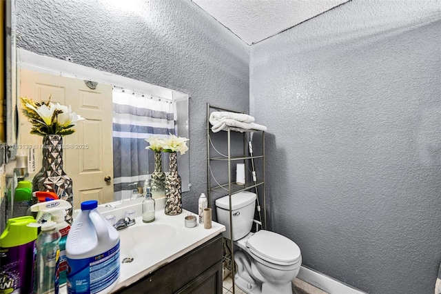 full bath featuring curtained shower, toilet, vanity, and a textured wall