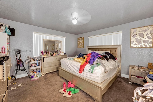 bedroom featuring a textured ceiling, baseboards, carpet, and a textured wall