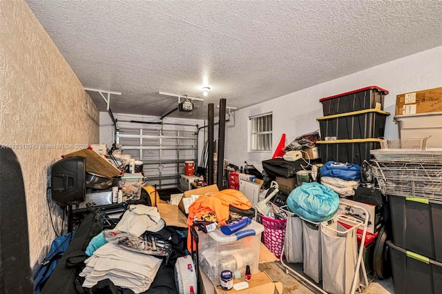 garage featuring a garage door opener and a textured wall