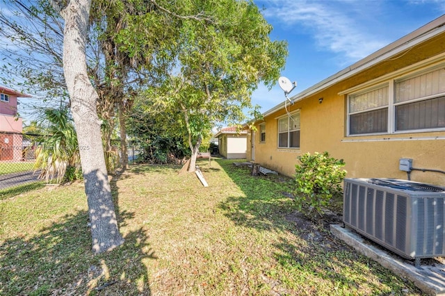 view of yard featuring central AC unit and fence