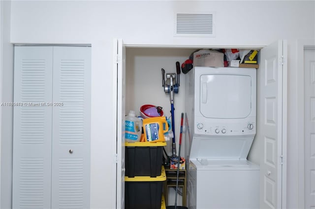 laundry room featuring stacked washer / dryer, laundry area, and visible vents