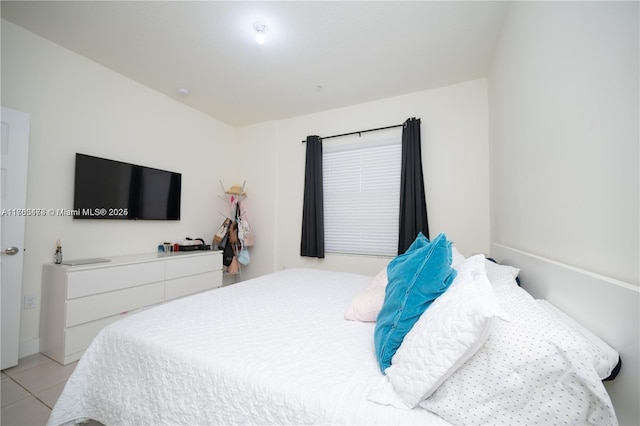 bedroom with light tile patterned floors