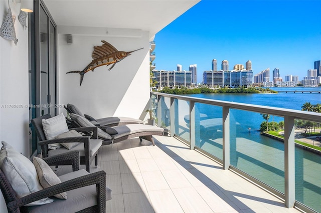 balcony featuring a view of city and a water view