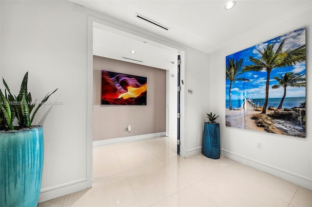 hall featuring tile patterned flooring, visible vents, recessed lighting, and baseboards