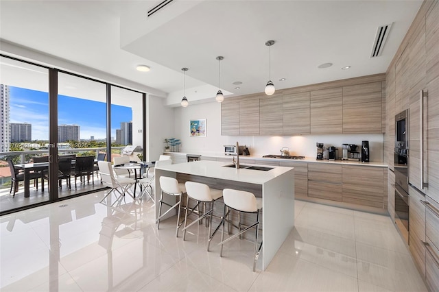 kitchen with light tile patterned floors, a kitchen bar, modern cabinets, and light countertops