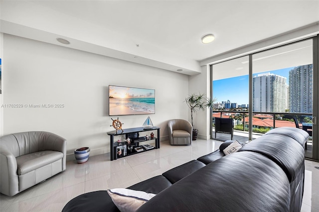 living room featuring tile patterned floors, baseboards, and expansive windows